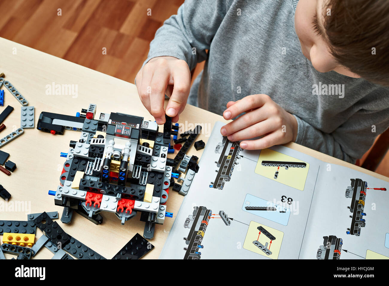 Little boy plays and collects the children's plastic construction toys Stock Photo