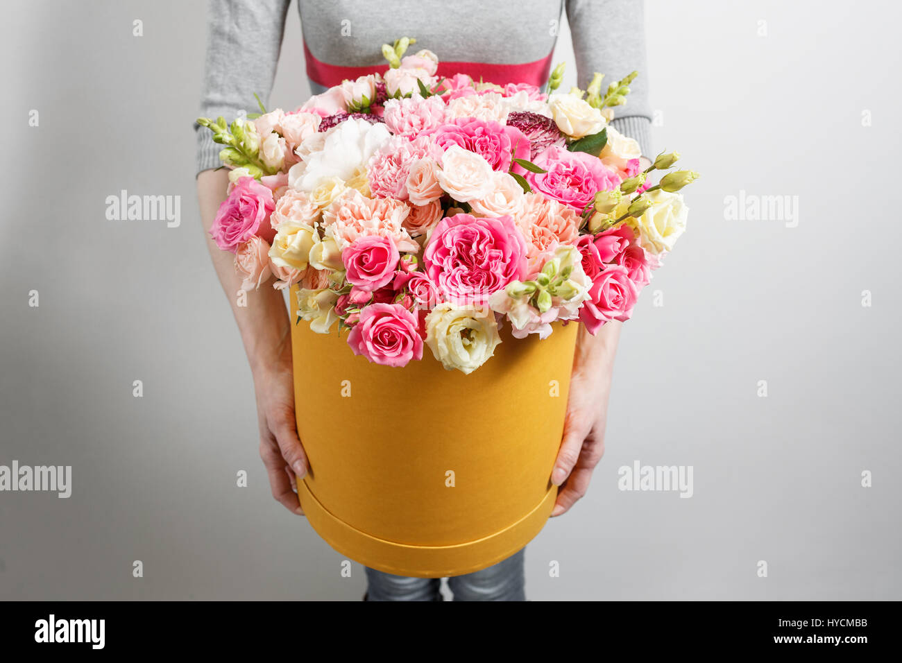 Luxury bouquets of flowers in the hat box. roses in the hands of women. Stock Photo