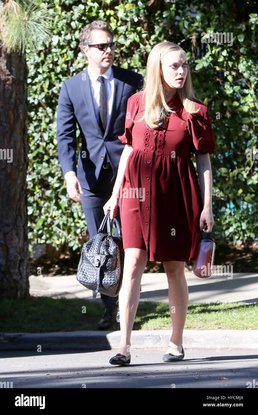 Pregnant Amanda Seyfried shows off her baby bump while out with her