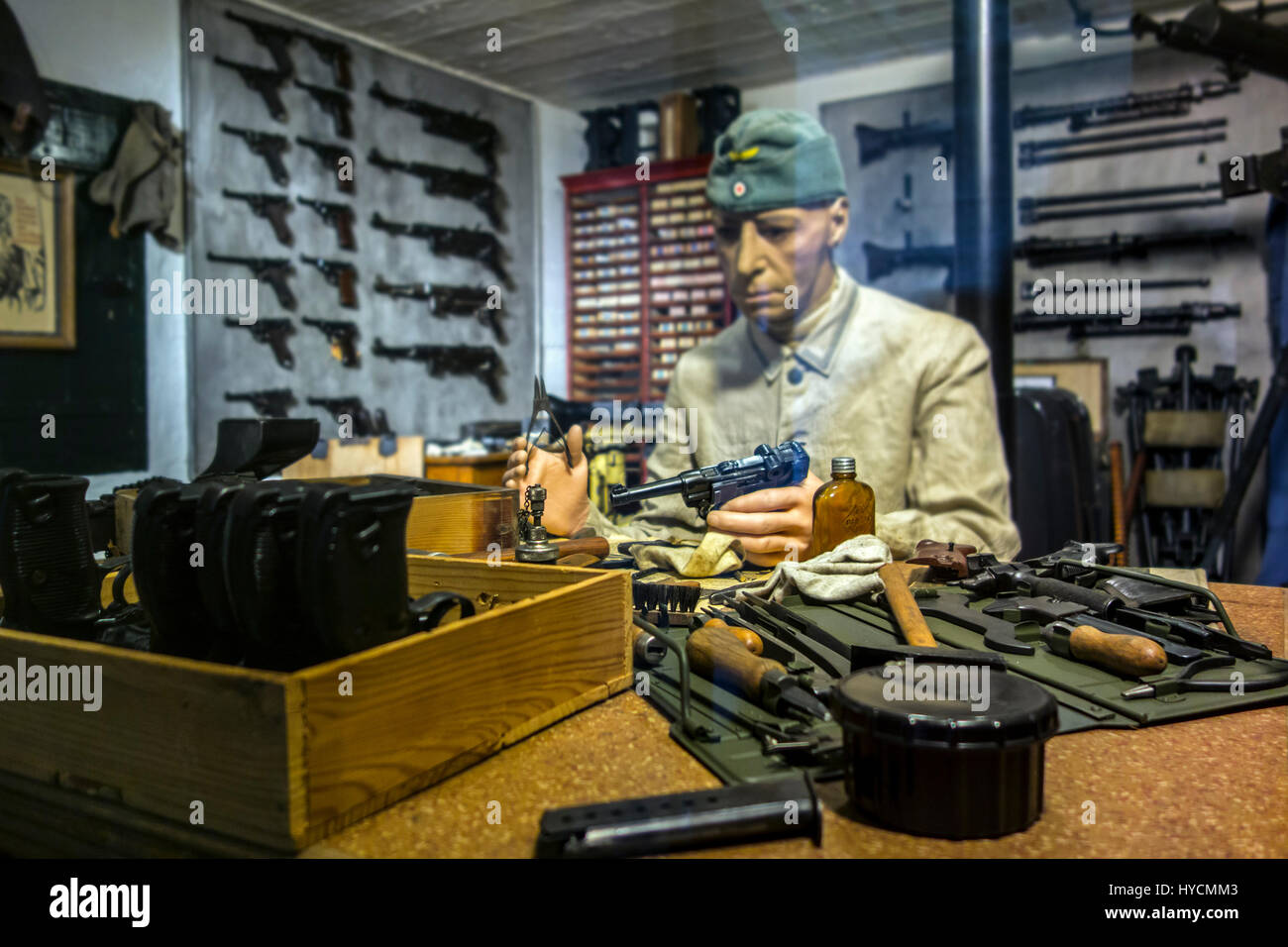 Diorama showing German WWII gunsmith repairing guns at arsenal