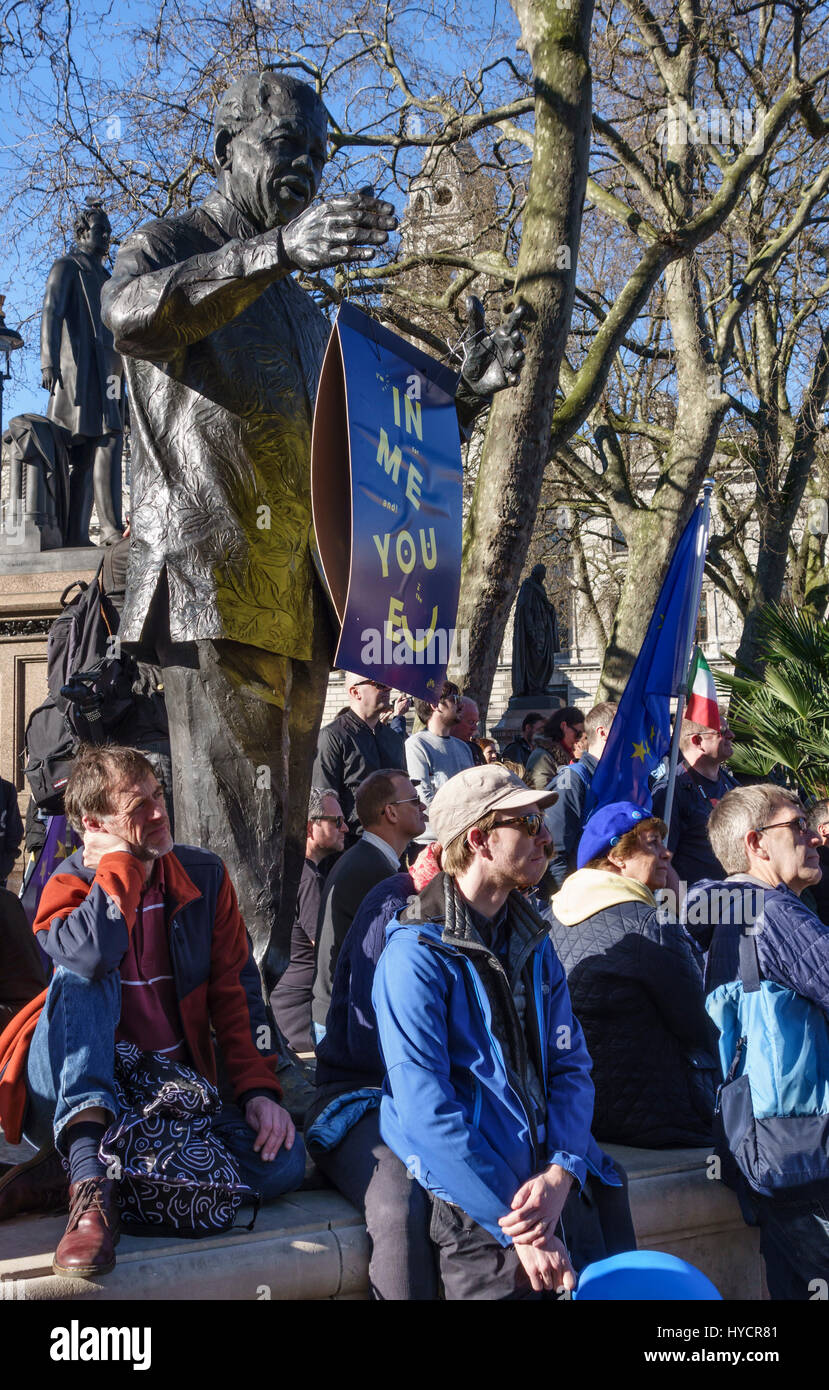 25th March 2017 - 100,000 people march in London against Brexit on the EU 60th anniversary. Protestors beside the Nelson Mandela statue Stock Photo