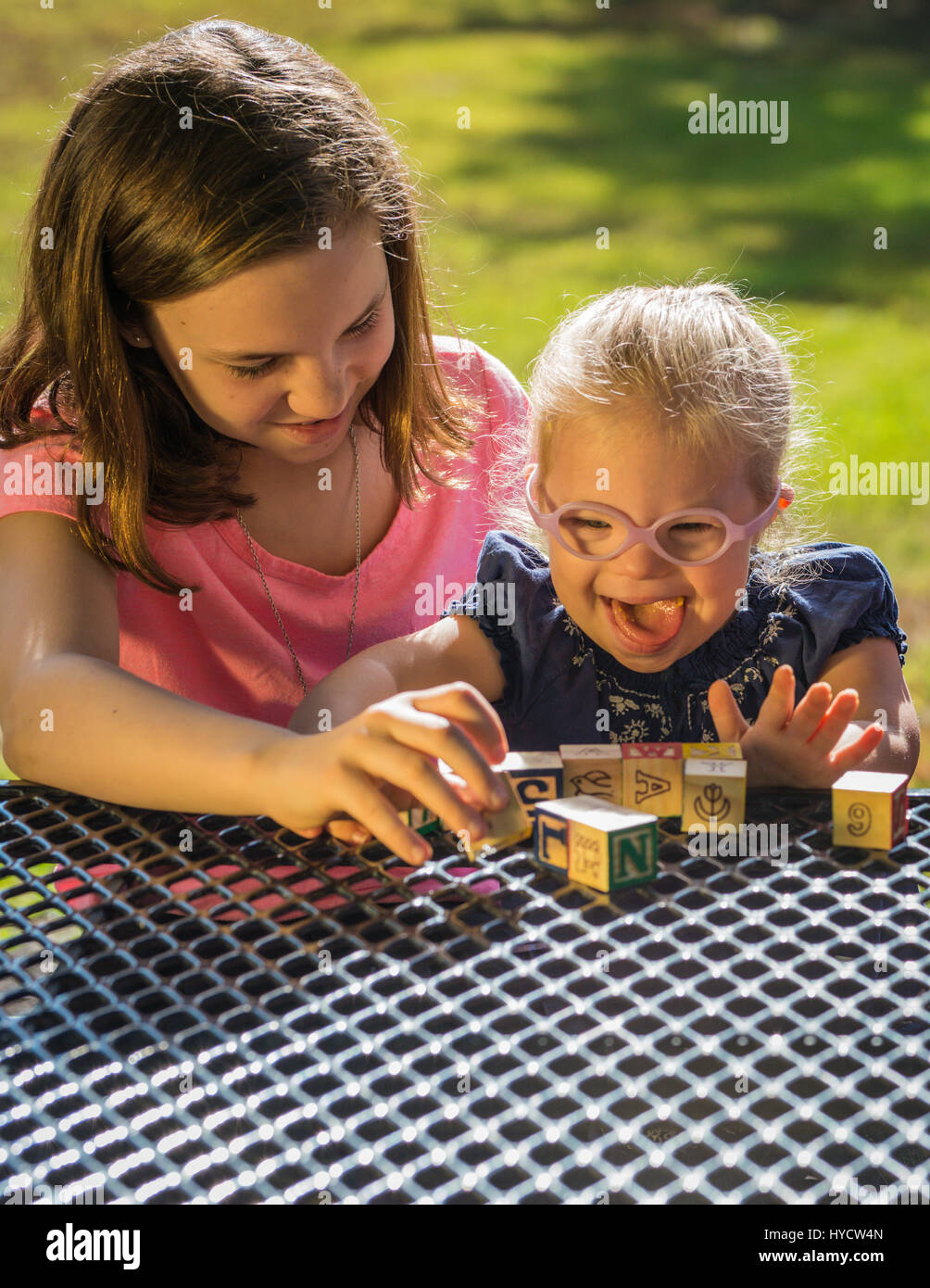 Sisters playing blocks/Down Syndrome Stock Photo