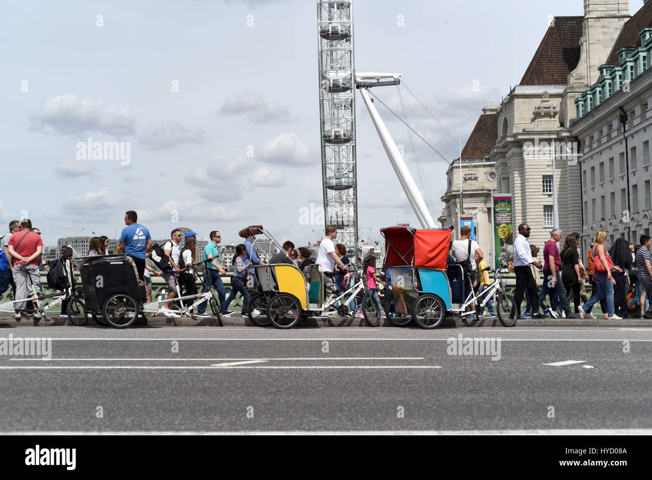 Tourists crossing Westminster Bridge near Millennium Wheel, London Stock Photo
