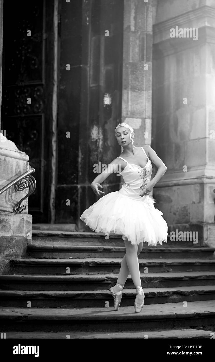 Young ballerina woman posing on stairs Stock Photo