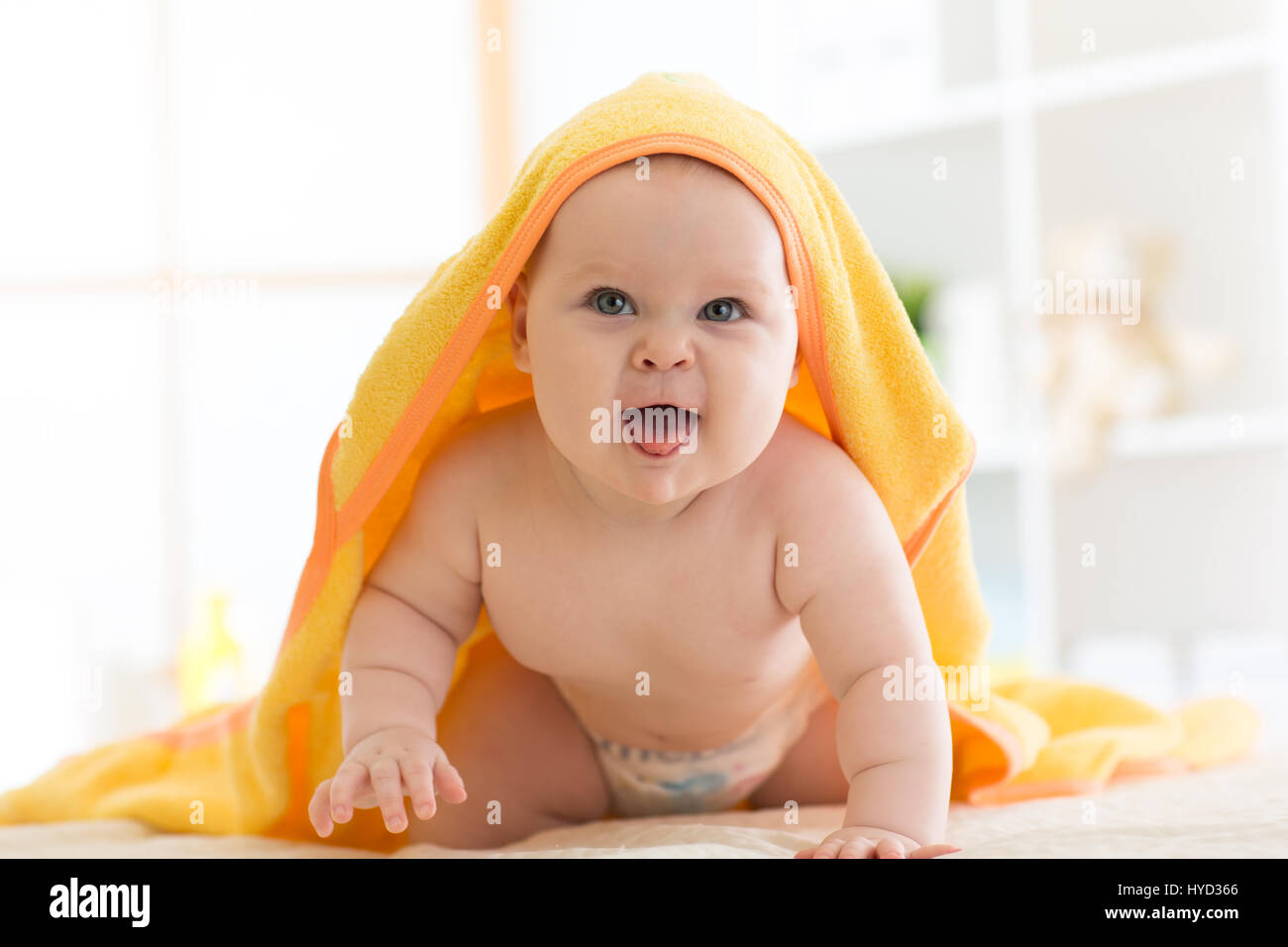 baby under the towel after bathing at home Stock Photo