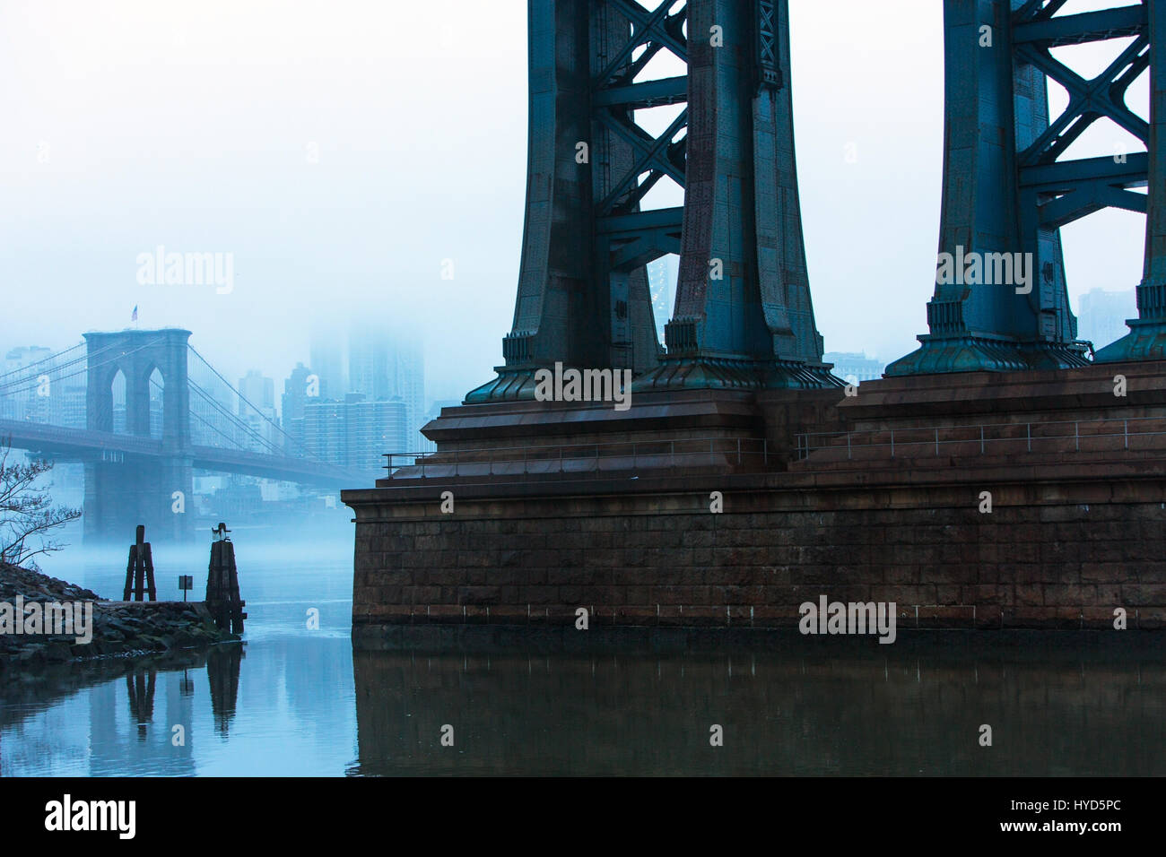 USA, New York, New York City, Manhattan, Brooklyn Bridge over East River in fog Stock Photo