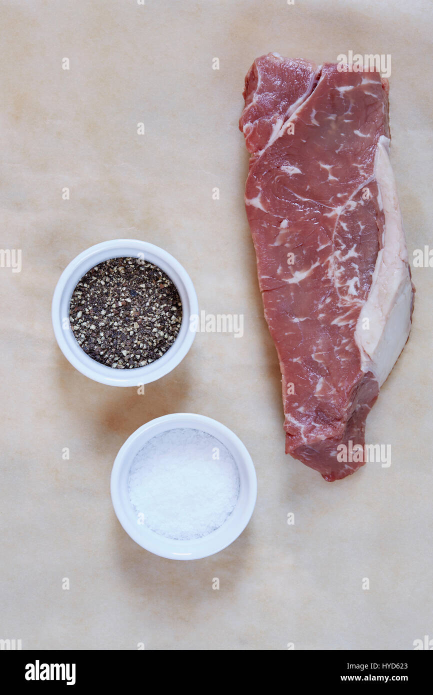 Raw rib eye steak on parchment paper Stock Photo - Alamy