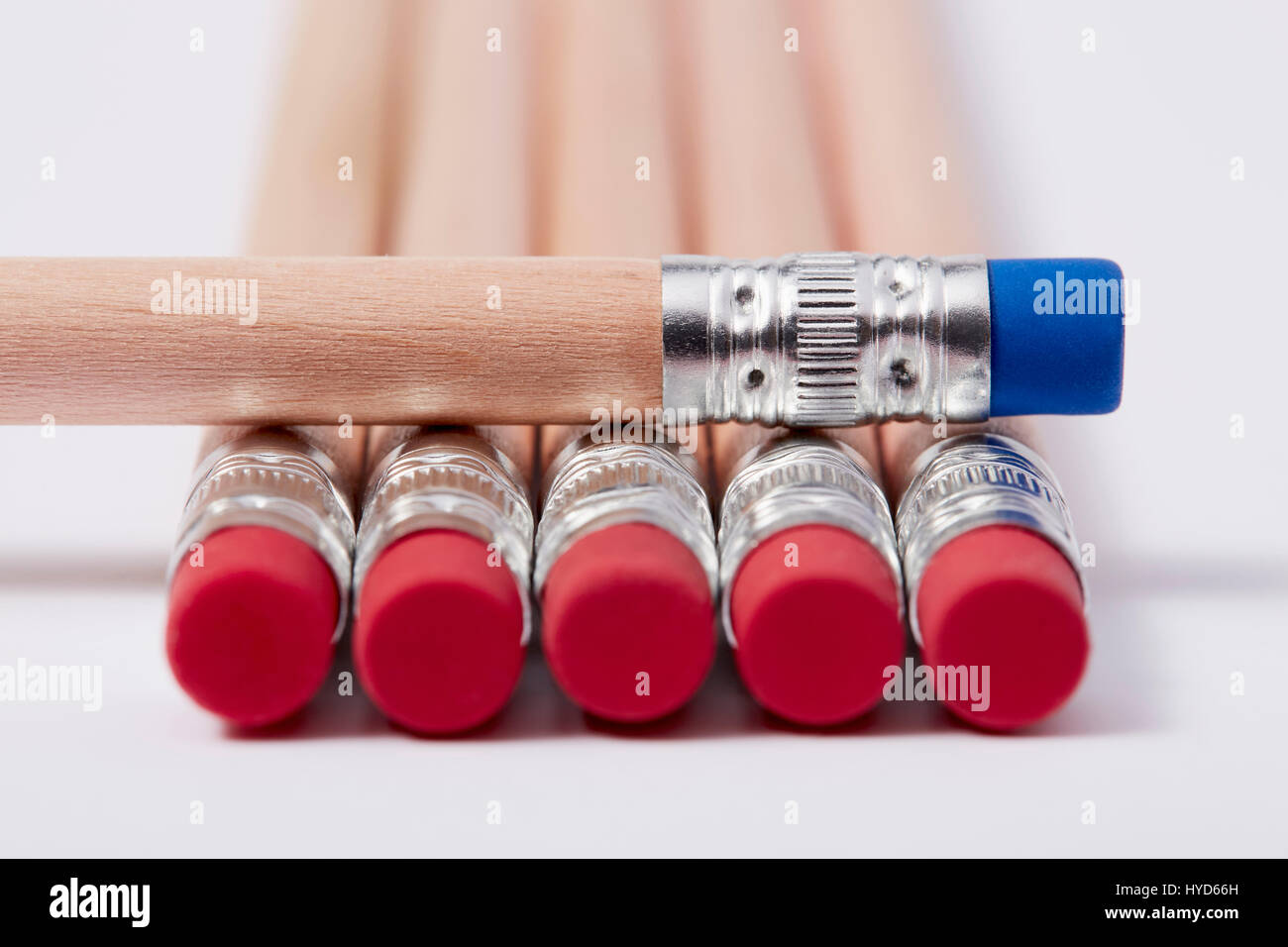 Wooden pencils with red erasers, one with blue on top Stock Photo