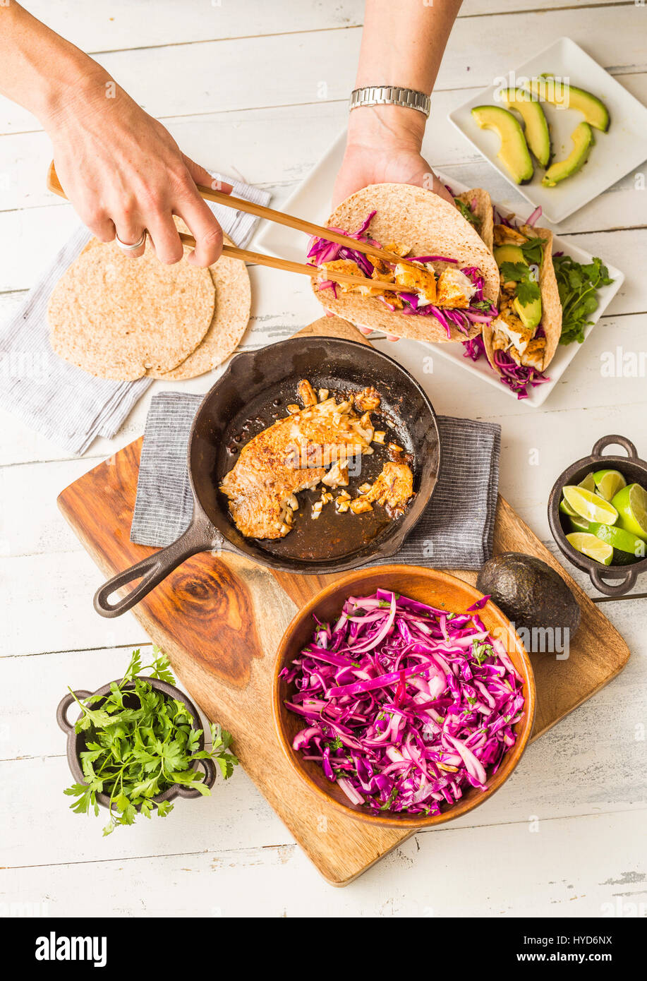 Woman preparing tortilla with tilapia and red cabbage Stock Photo Alamy