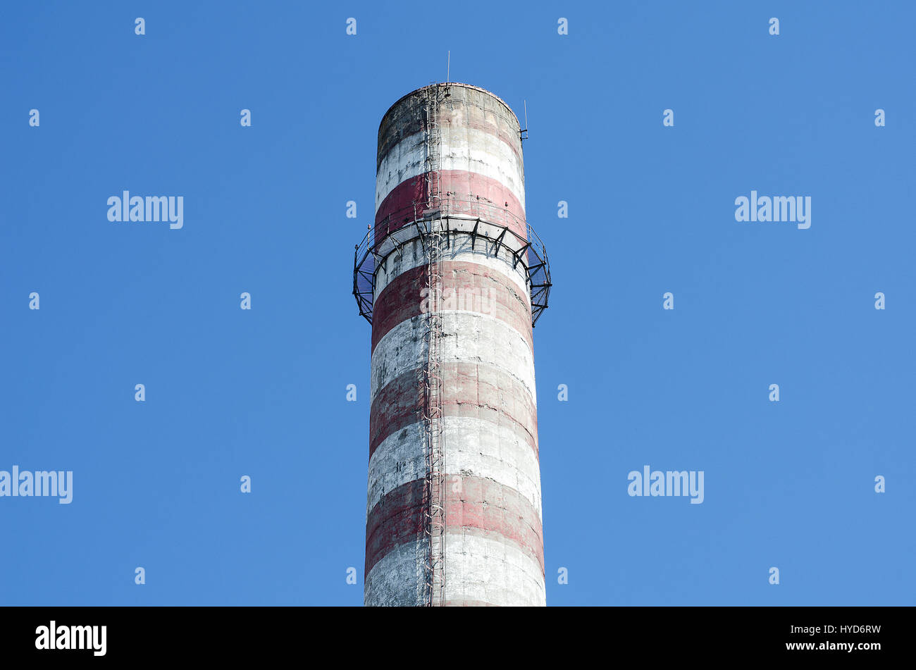 Industrial chimney against blue sky Stock Photo