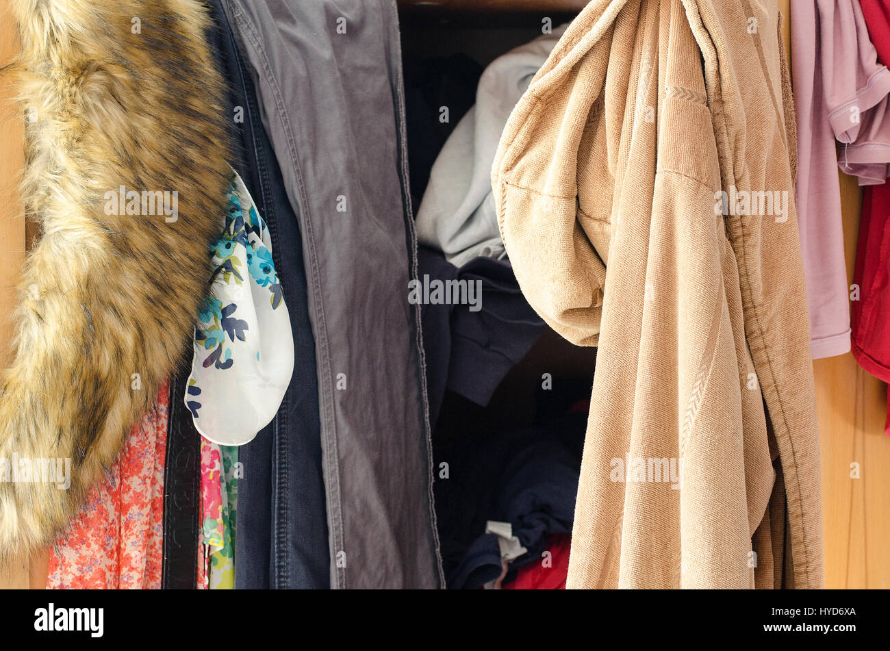 Pile of carelessly scattered clothes in wardrobe Stock Photo