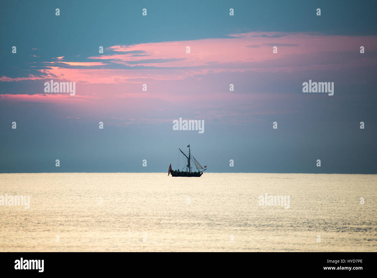 sea with waves and boats before sunset Stock Photo - Alamy