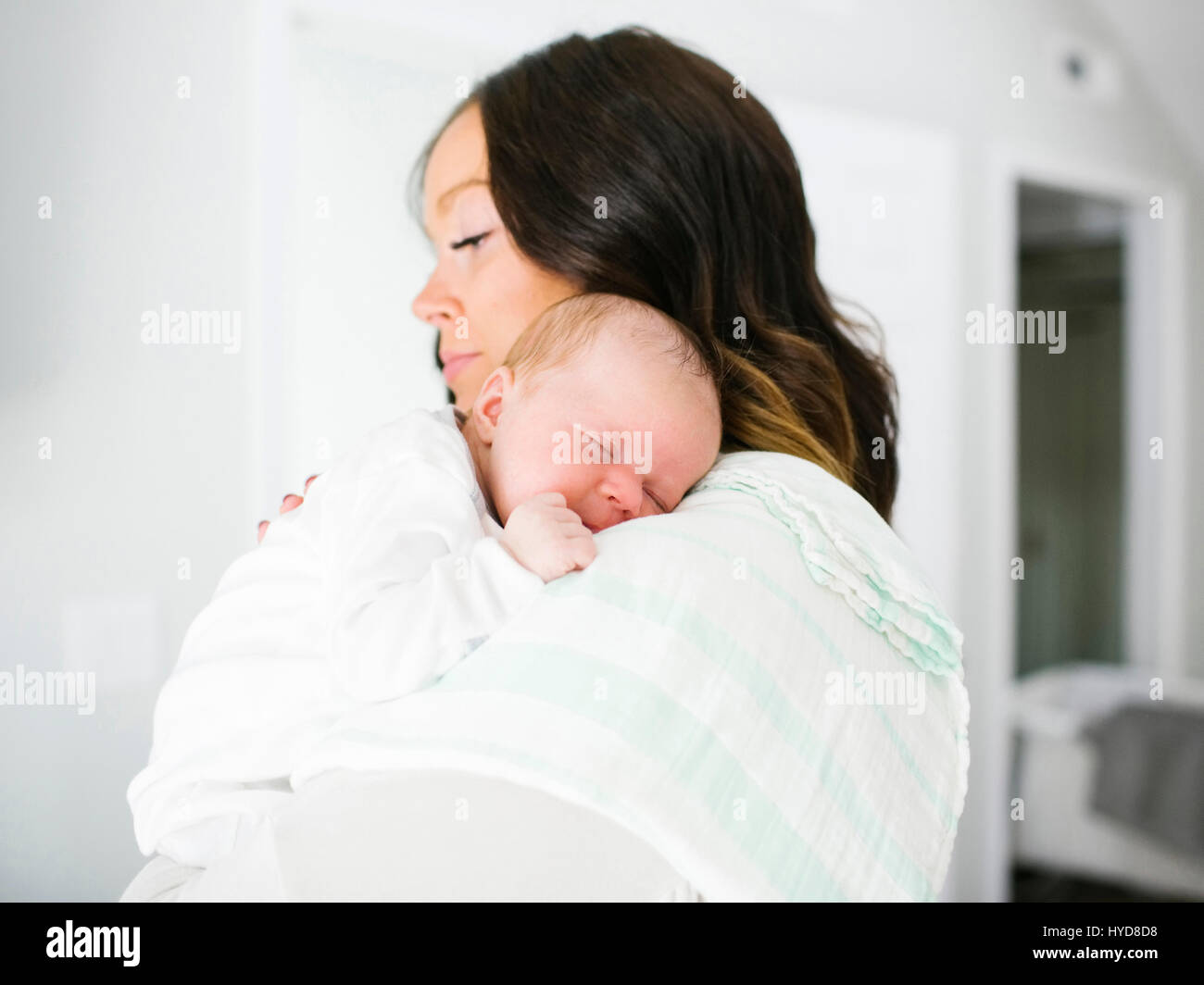 Mother carrying daughter (0-1 months) Stock Photo