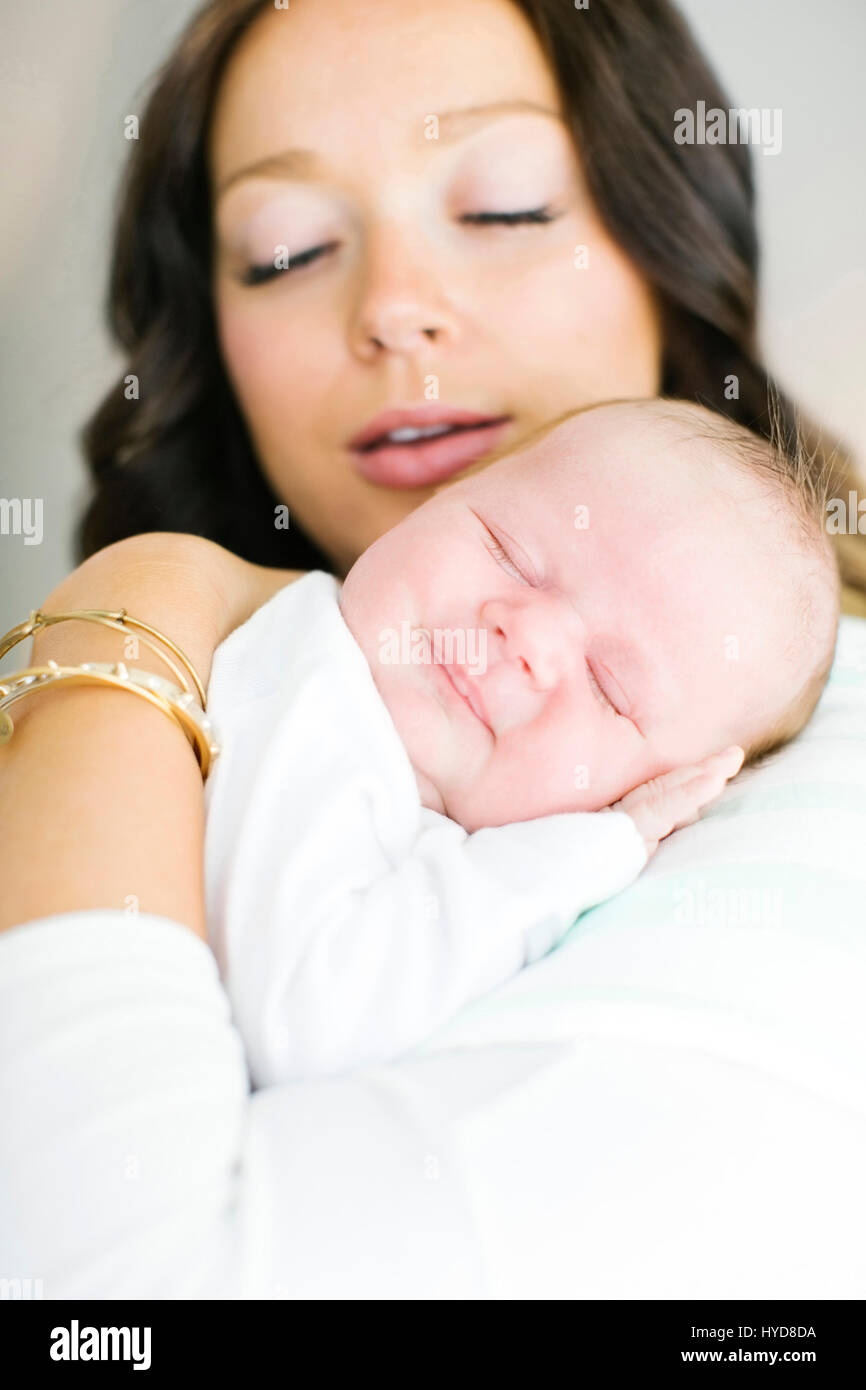 Mother carrying daughter (0-1 months) Stock Photo