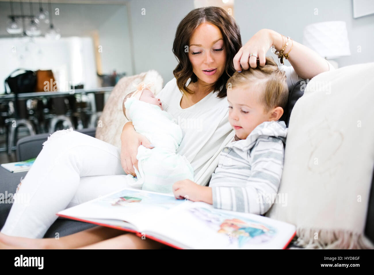 Woman spending time with children (0-1 months, 4-5) Stock Photo
