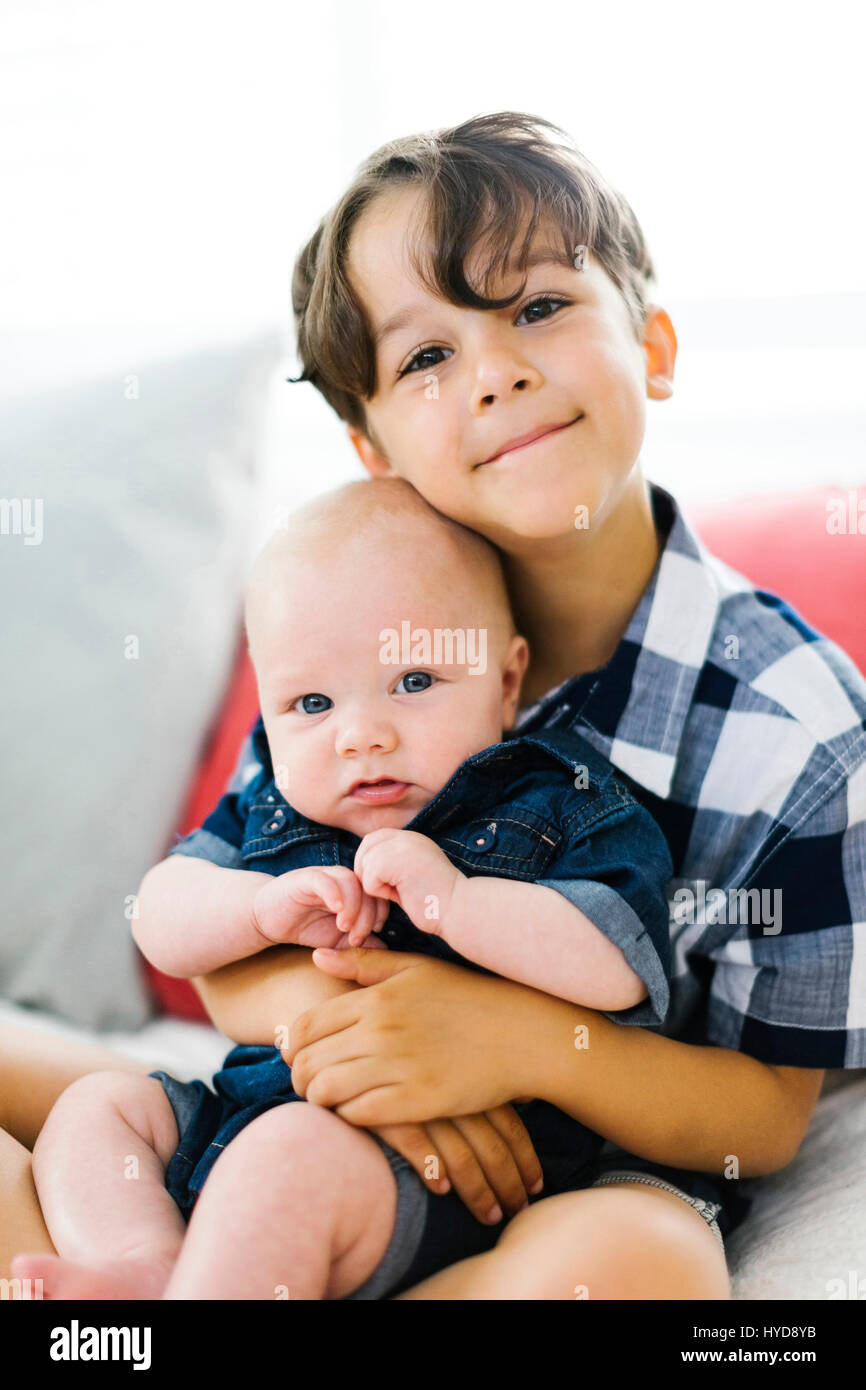 Young boy holding baby brother hires stock photography and images Alamy