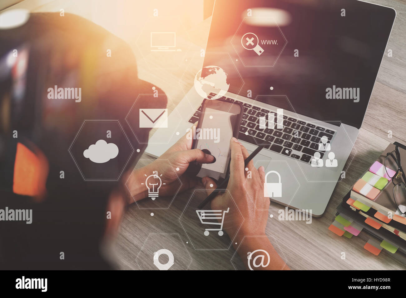 businessman working with smart phone and laptop computer on wooden desk ...