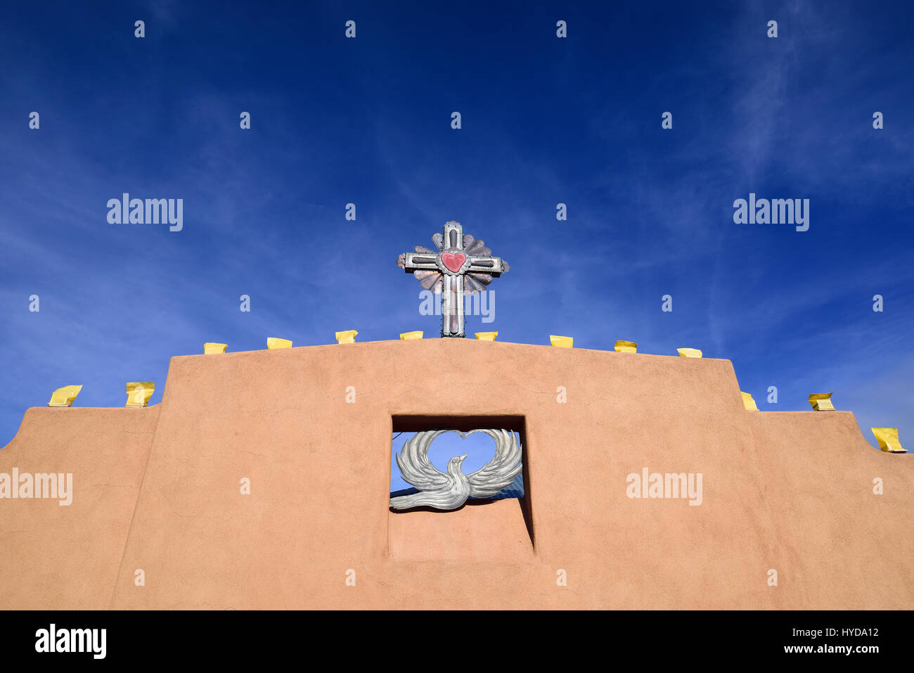 USA, NEW MEXICO, CHIMAYO, RELIGIOUS SYMBOLS ON ADOBE WALL Stock Photo