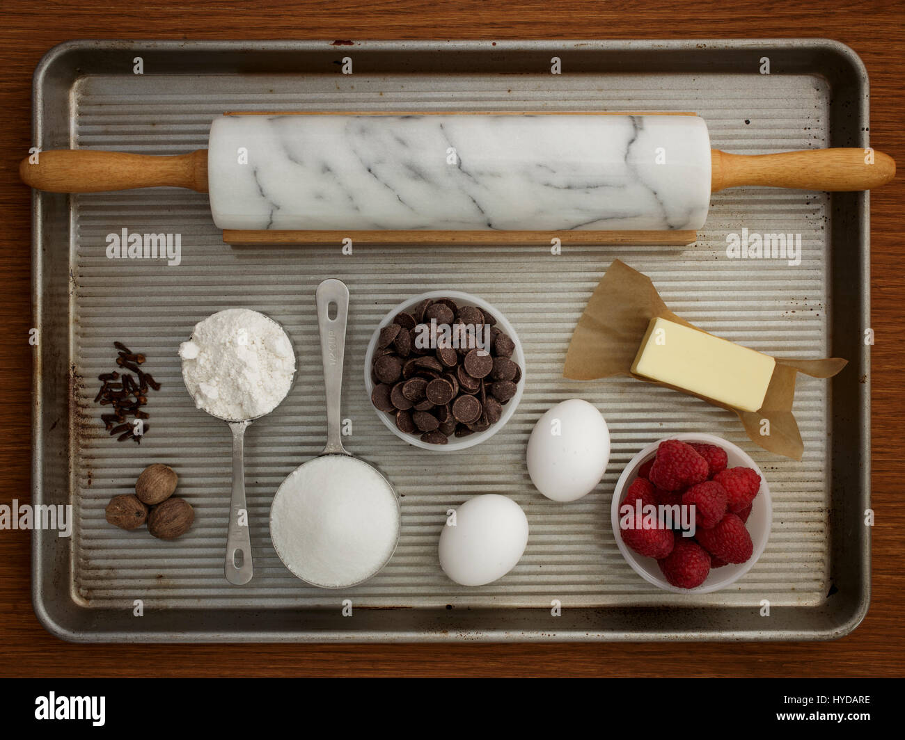 Studio shot of baking sheet with rolling pin and fresh ingredients Stock Photo