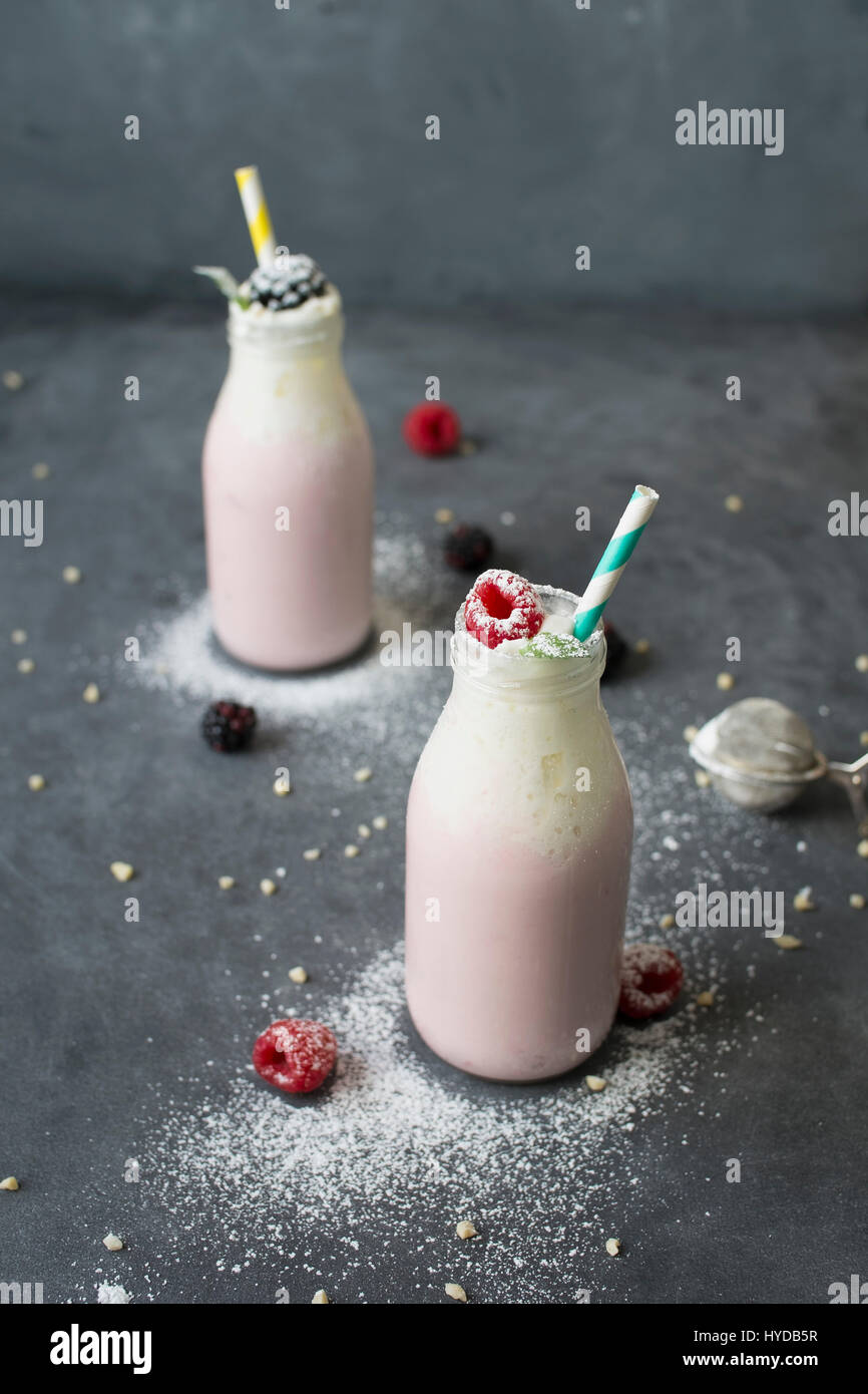 Studio shot of raspberry milkshake in bottles Stock Photo