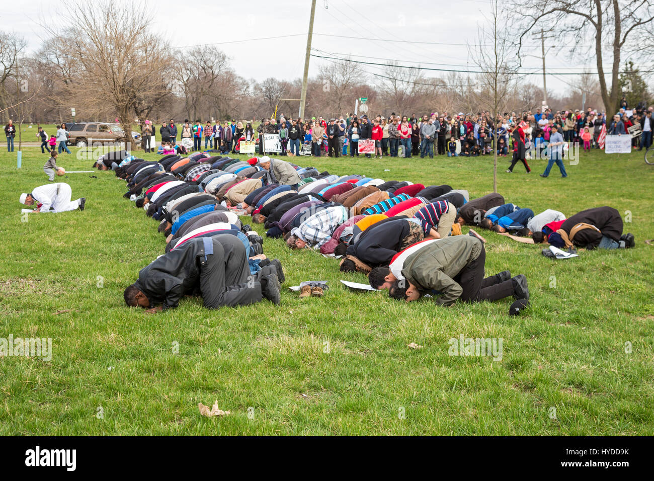 Dearborn, Michigan - Muslim men pray in a park near the American Muslim Society's mosque. The Friday prayers came at the end of a unity march with mos Stock Photo