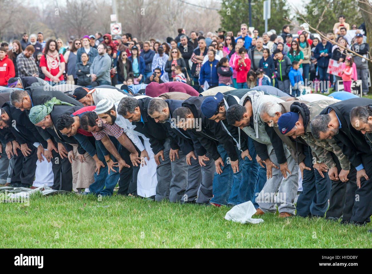 Dearborn, Michigan - Muslim men pray in a park near the American Muslim Society's mosque. The Friday prayers came at the end of a unity march with mos Stock Photo