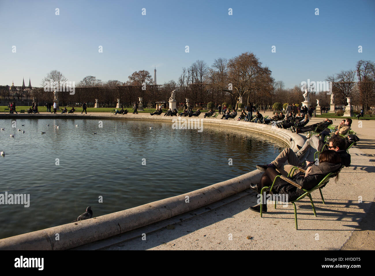People relaxing and enjoying a sunny day in Jardin des Tuileries near musée du Louvre and Champs Elysées, Paris, France Stock Photo