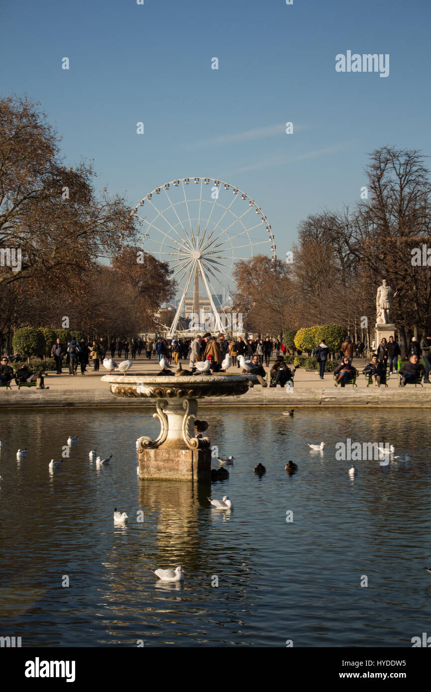 People relaxing and enjoying a sunny day in Jardin des Tuileries near musée du Louvre and Champs Elysées, Paris, France Stock Photo
