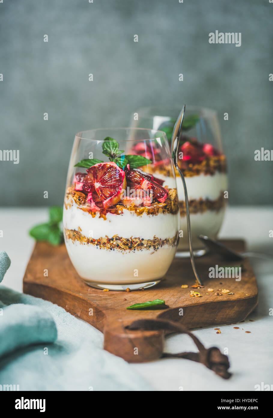 Healthy breakfast glasses with yougurt, granola and orange Stock Photo