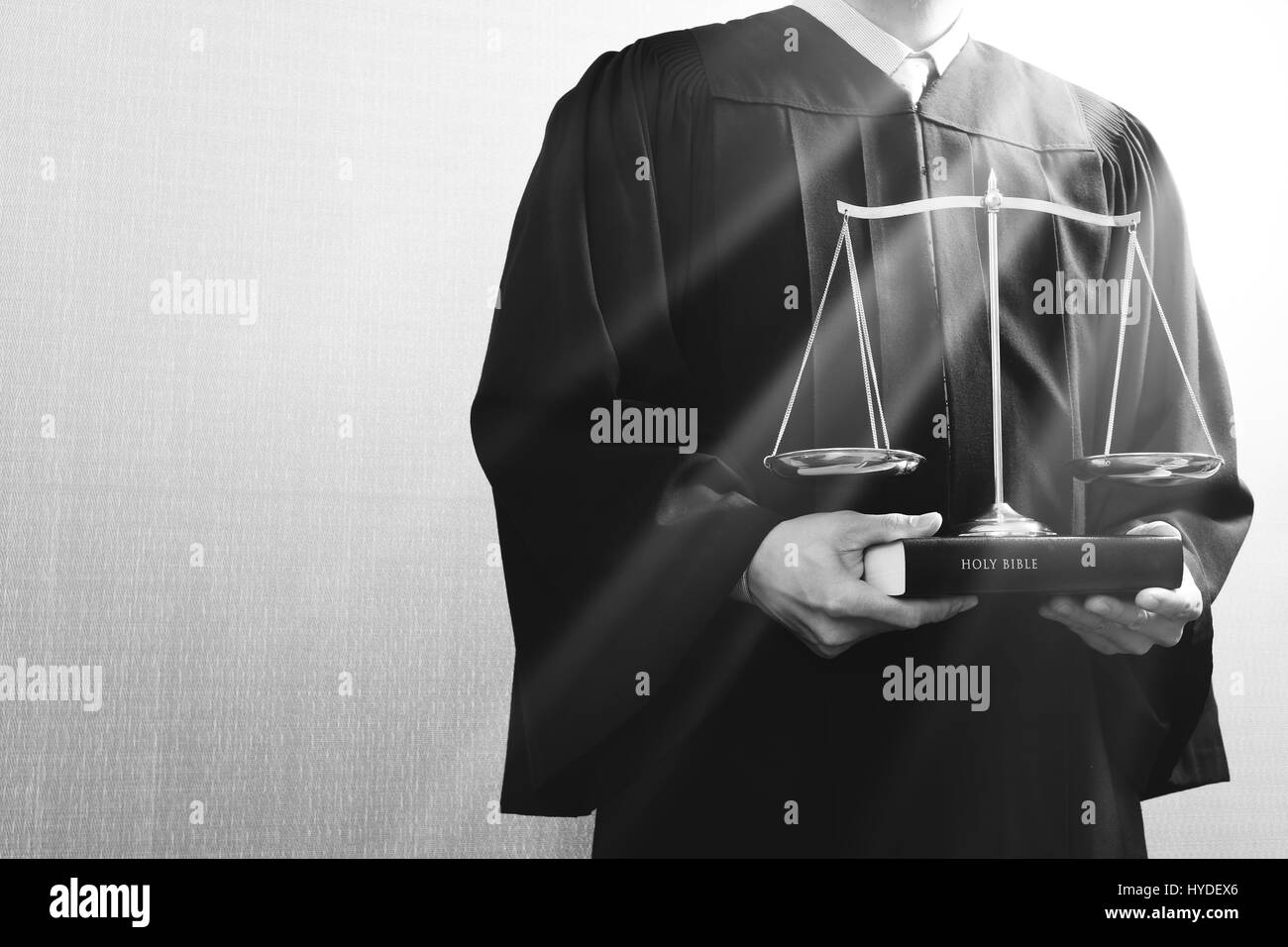 justice and law concept.Male judge in a courtroom with the balance scale and holy book,black and white Stock Photo
