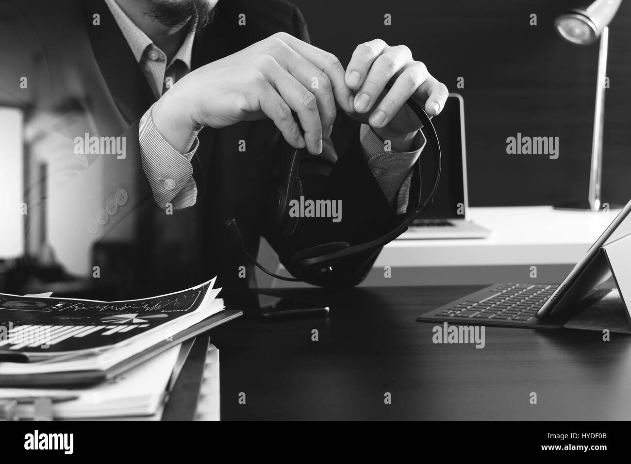 Man using VOIP headset with digital tablet computer as concept communication or it support or call center and customer service in modern office,black  Stock Photo