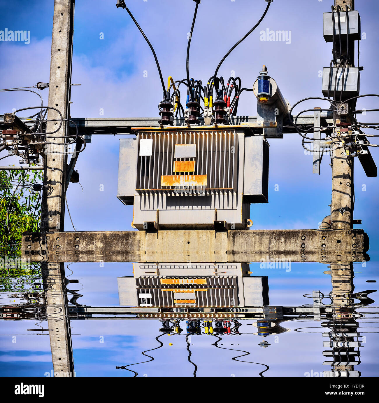 High voltage transformer on high power station with reflection Stock Photo