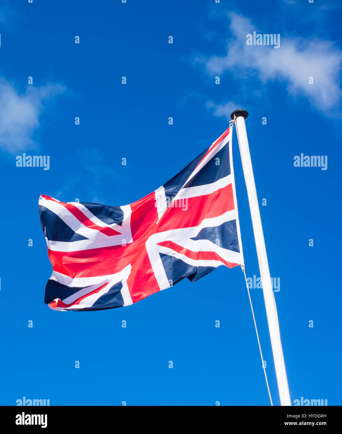 Union Jack flag against blue sky Stock Photo