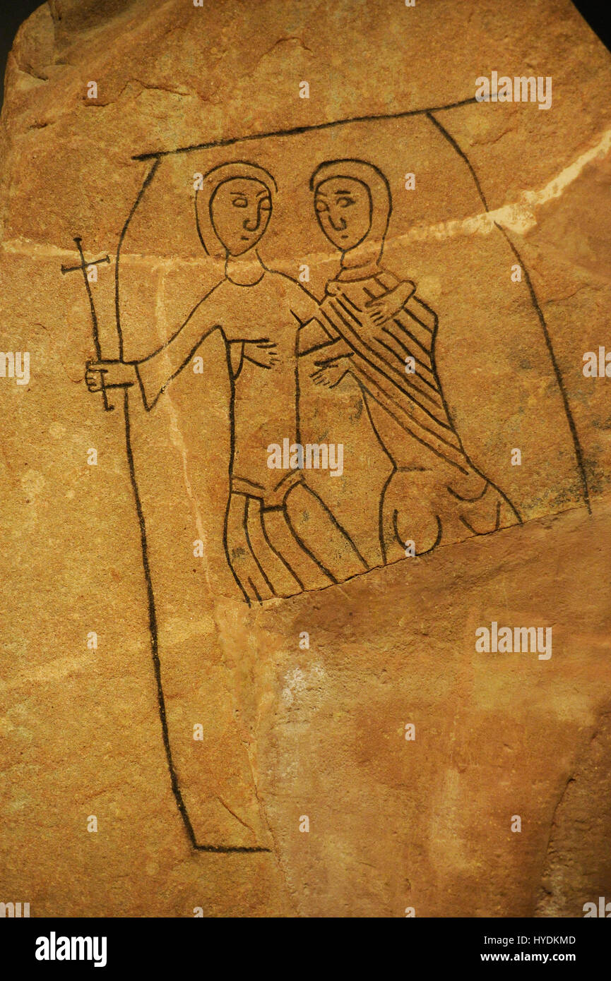 Runestone erected by Nikulaus in memory of his father Sysha. Detail. It probably represents the entrance of the father into the Kingdom of Heaven. One of them carries a cross in his hands and appears to enter a portal that could be the gates of heaven. Swedish History Museum. Stockholm. Sweden. Stock Photo