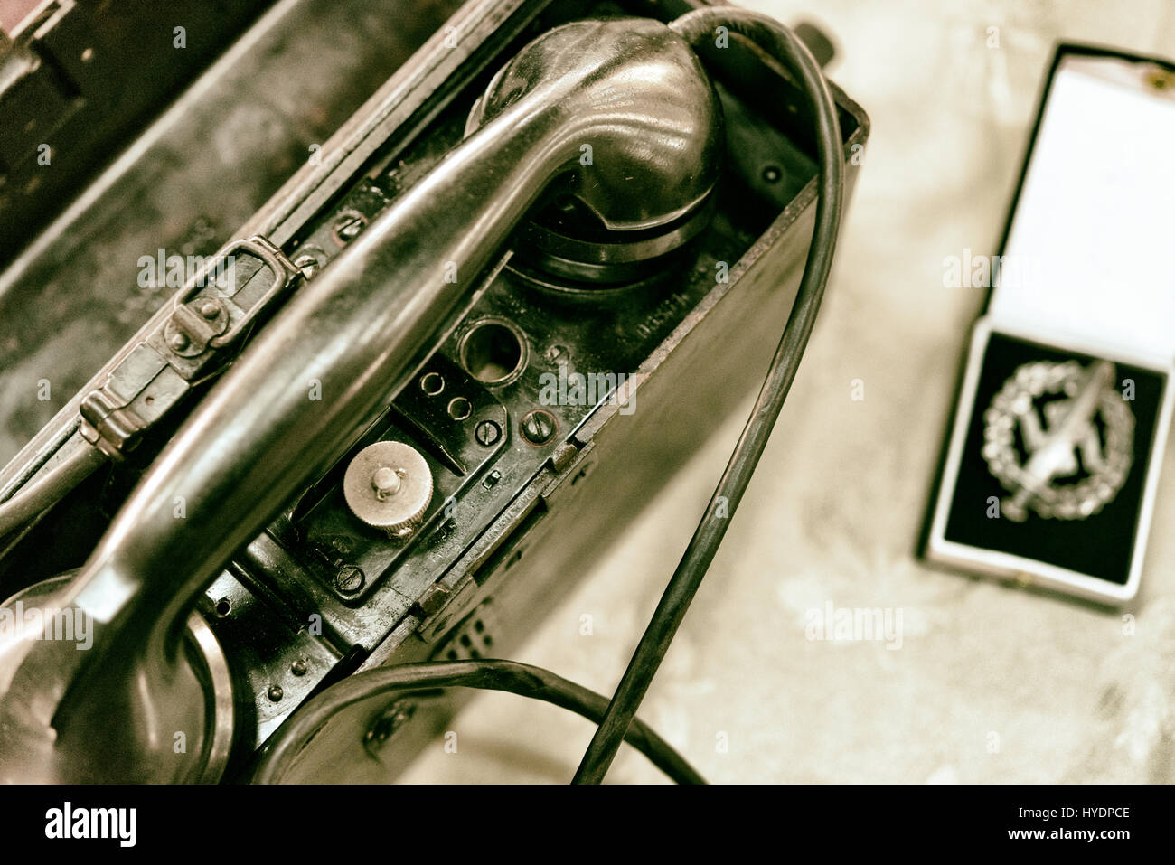 Army field telephone next to a German army medal, vintage Stock Photo