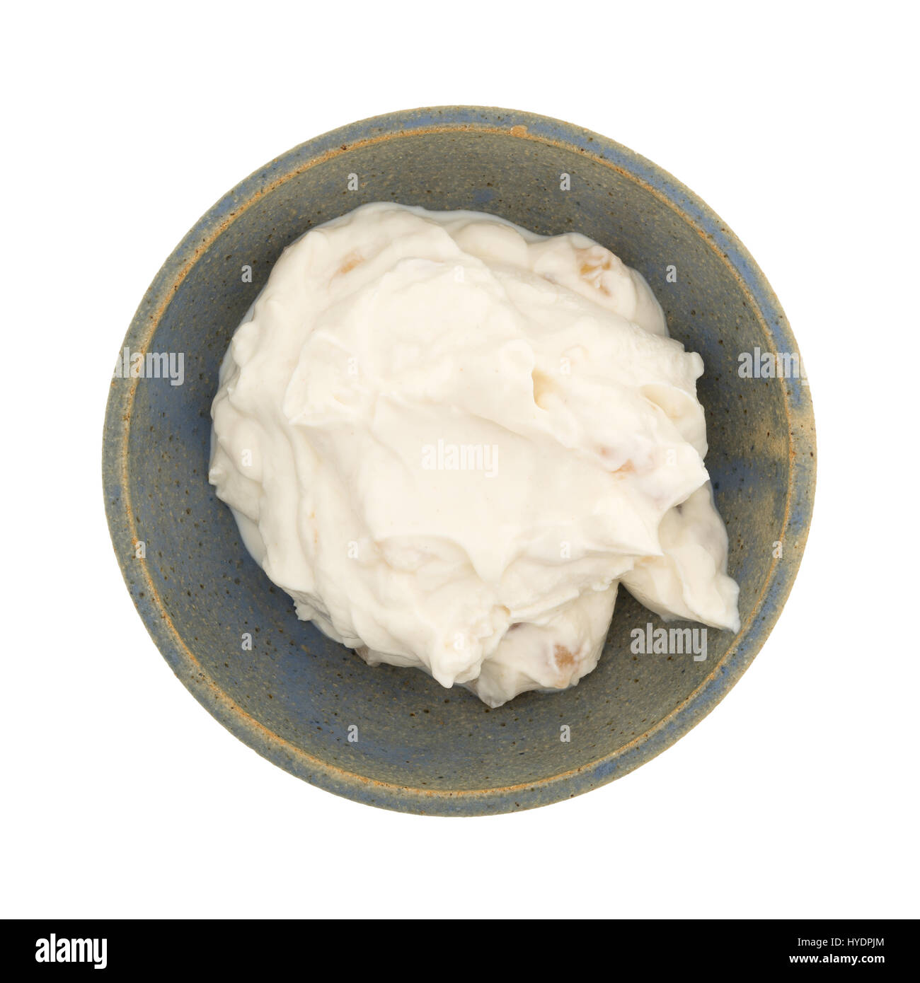 Top view of a serving of apple vanilla Greek yogurt in an old stoneware bowl isolated on a white background. Stock Photo