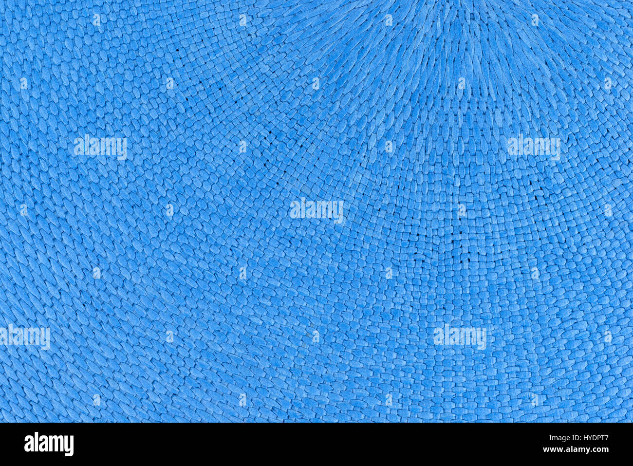 A very close view of a place mat made with woven blue dyed cloth. Stock Photo