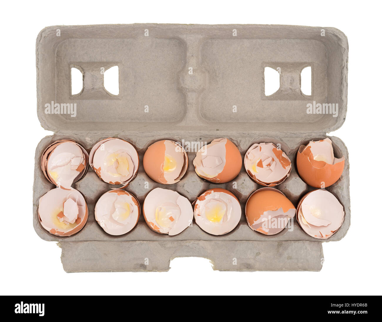 Top view of a dozen used egg shells in a cardboard container isolated on a white background. Stock Photo