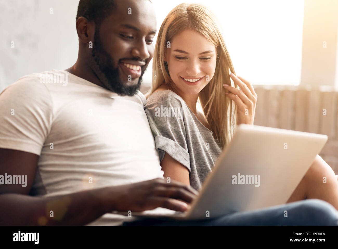 Peaceful international couple relaxing at home Stock Photo