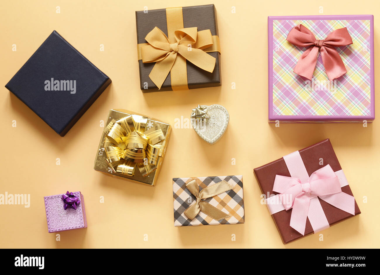 A lot of gift boxes with bows on a beige background Stock Photo - Alamy
