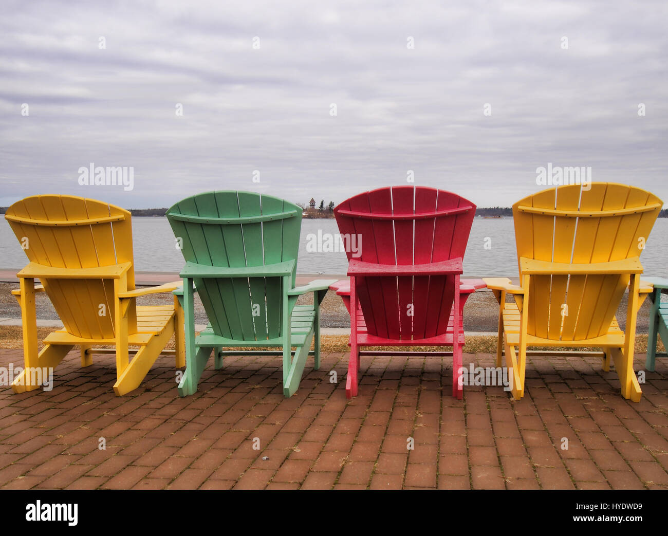 Adirondack chairs on the shore of The Saint Lawrence River facing The Thousand Islands in Clayton, New York Stock Photo