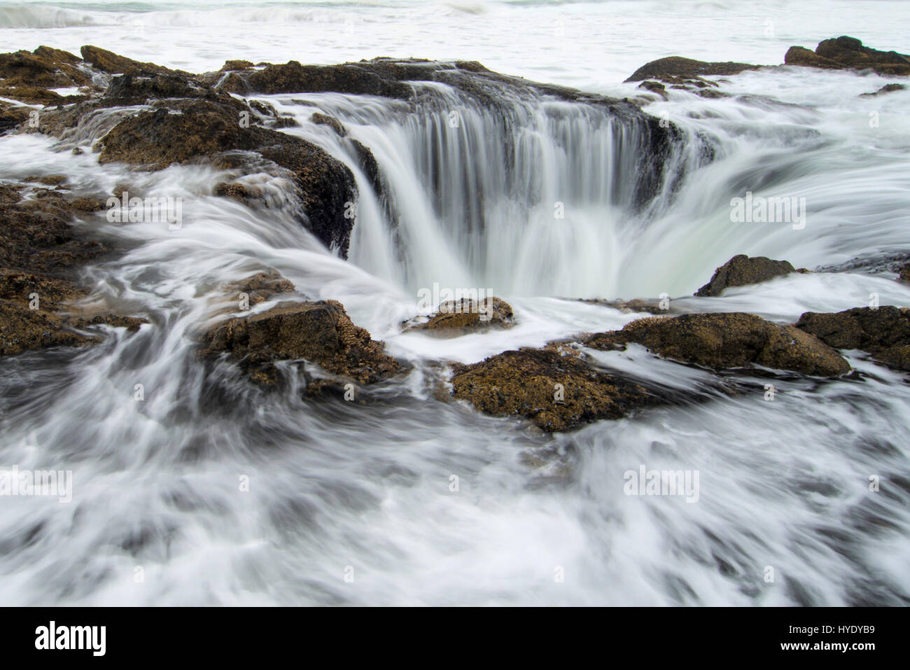 Thor's Well is a bowl-shaped hole carved out of the rough basalt