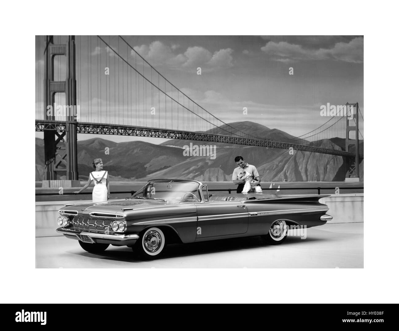 1959 Chevrolet Impala 2 door convertible with San Francisco Golden Gate Bridge behind a full-size convertible car built by Chevrolet Motor Company Stock Photo