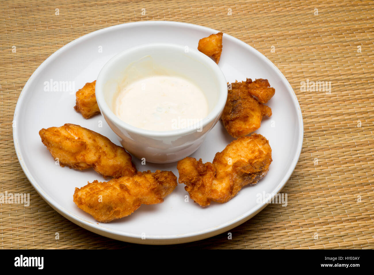 deep fried grouper fingers on white plate with dipping sauce Stock