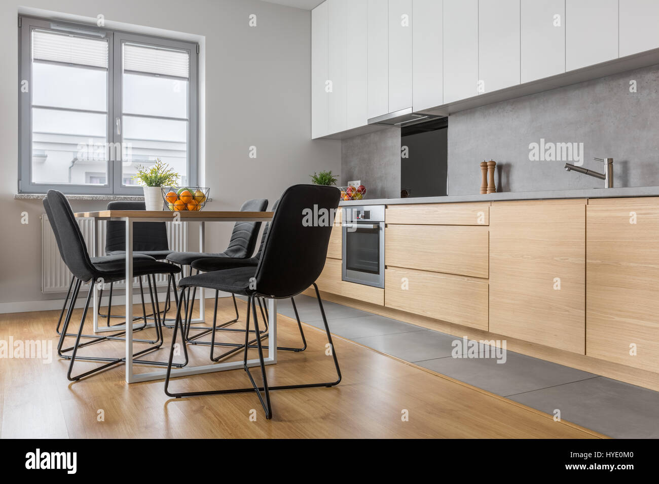 Modern Kitchen With Long Countertop Table Chairs And Wooden