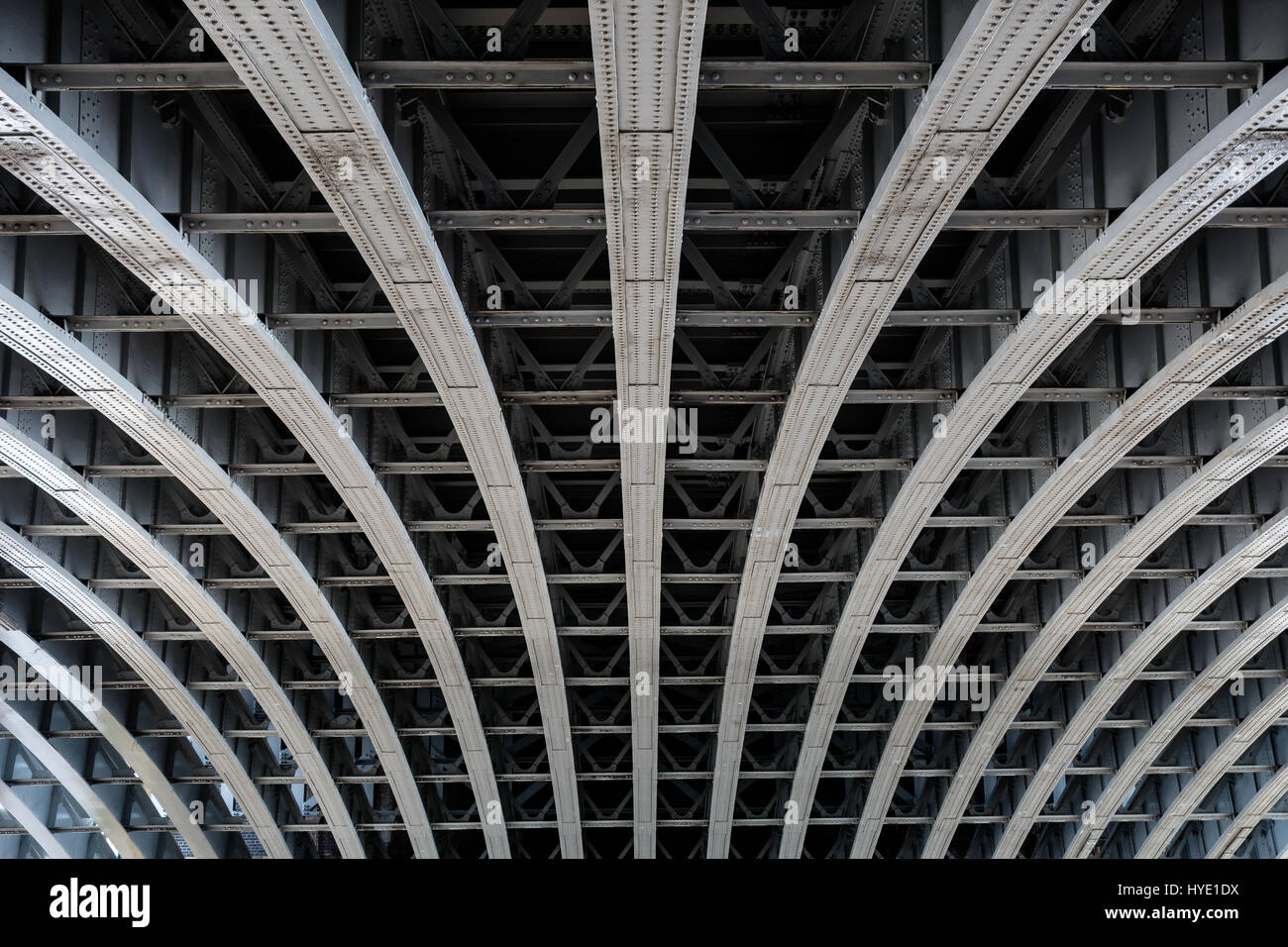 Detail of riveted steel beams supporting span of bridge crossing the River Thames Stock Photo