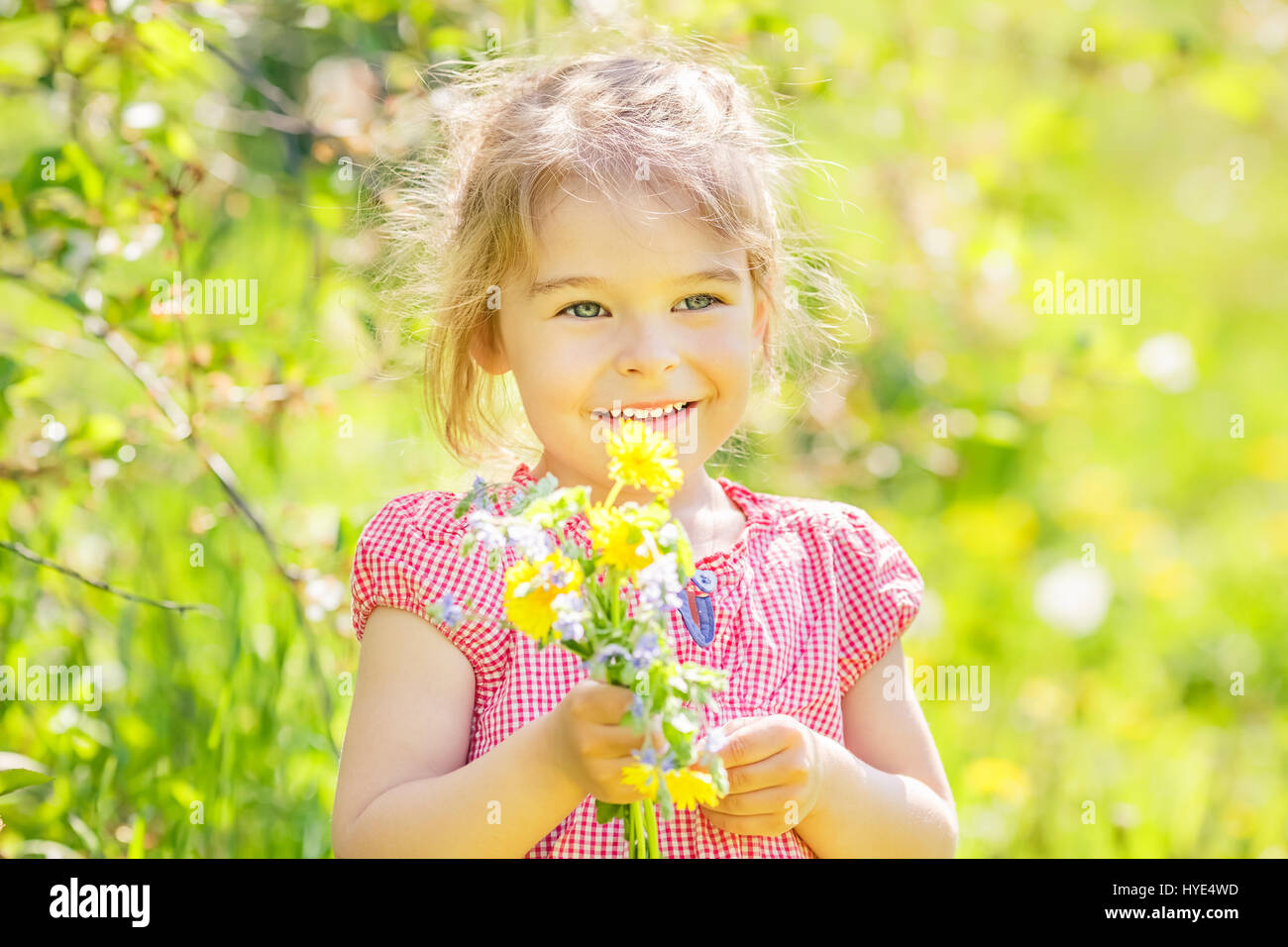 Happy little girl in spring sunny park Stock Photo - Alamy