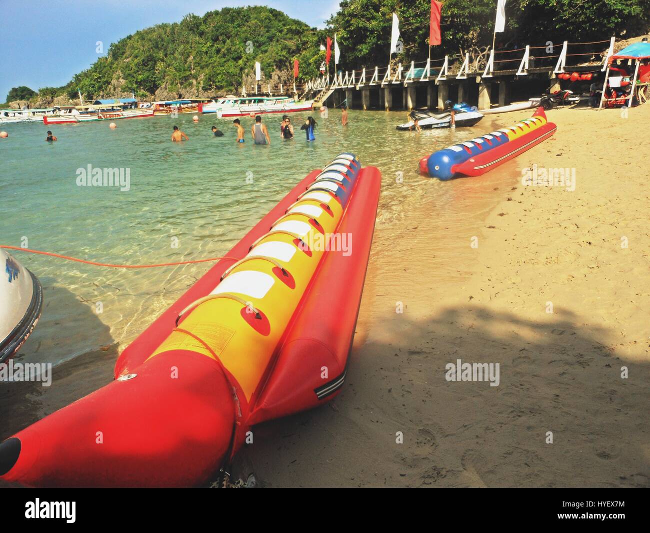 Empty banana boats lying on the sand in a beach in Hundred Islands
