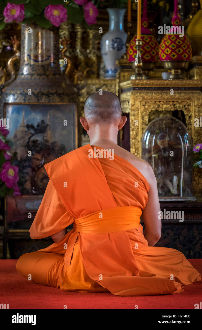 BANGKOK, THAILAND - CIRCA SEPTEMBER 2014: Buddhist monk praying inside the Ordination Hall in Wat Arun, a  popular Buddhist temple in Bangkok Yai dist Stock Photo