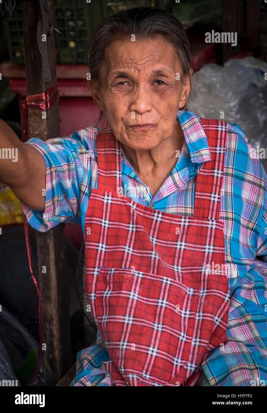 MAE KLONG - TAHILAND - CIRCA SEPTEMBER 2014: Portrait of Thai woman, a merchant of the Maeklong Railway Market Stock Photo